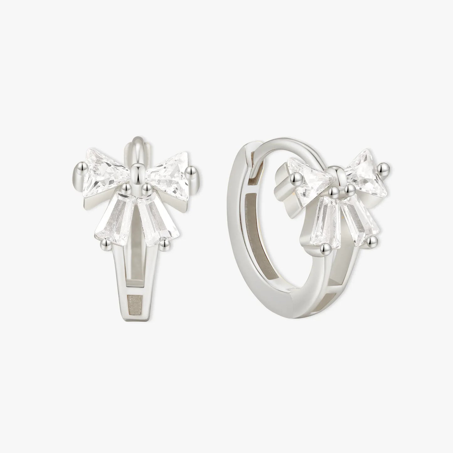 Silver bow-shaped earrings on a white background