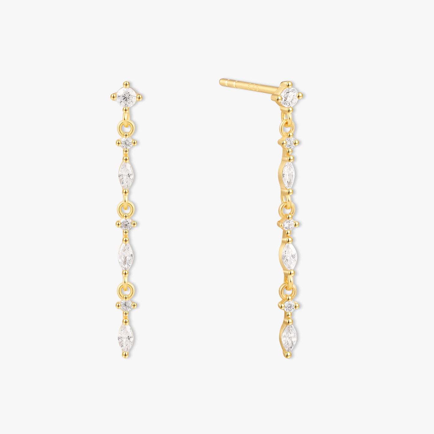 Gold and pearl drop earrings on a white background