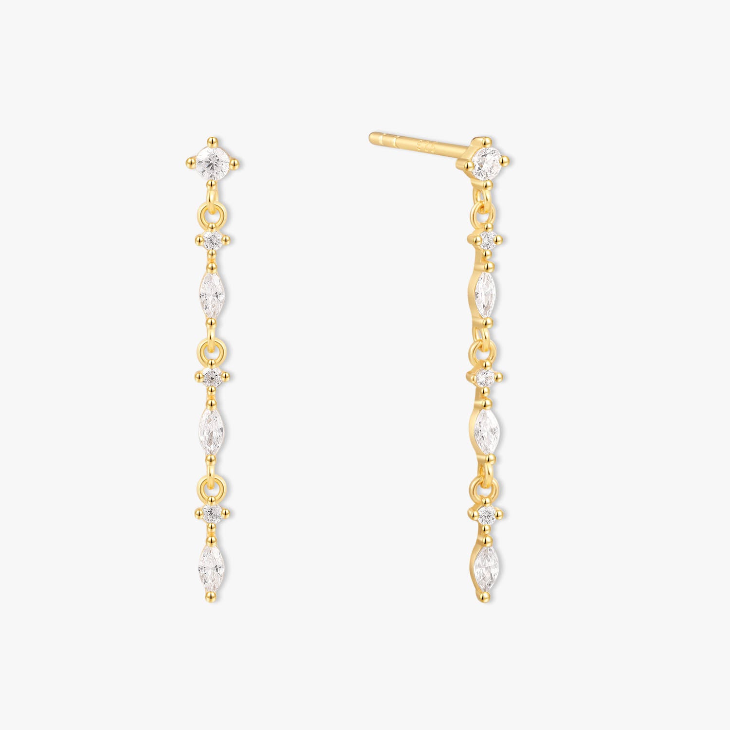 Gold and pearl drop earrings on a white background
