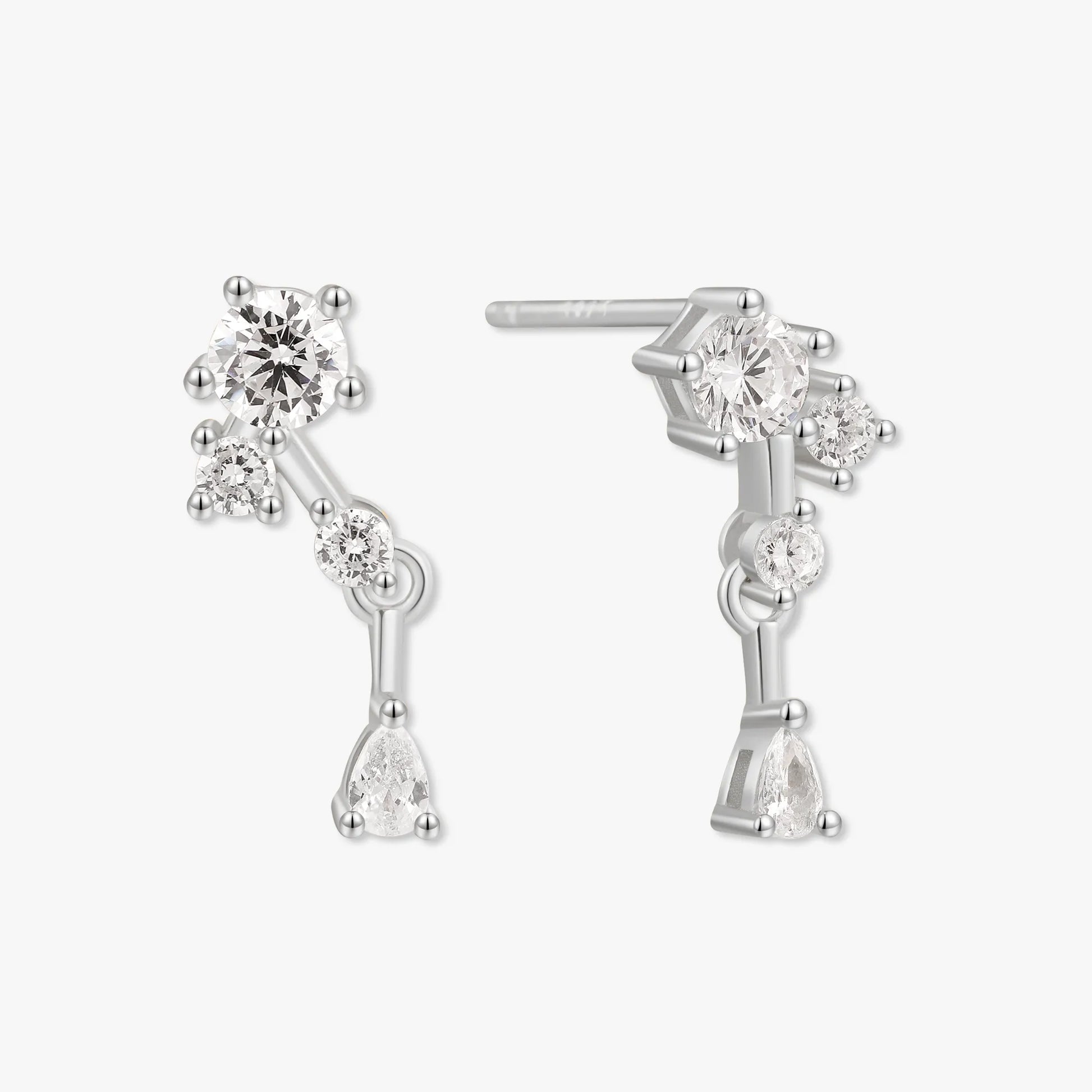 Silver earrings with clear gemstones on a white background