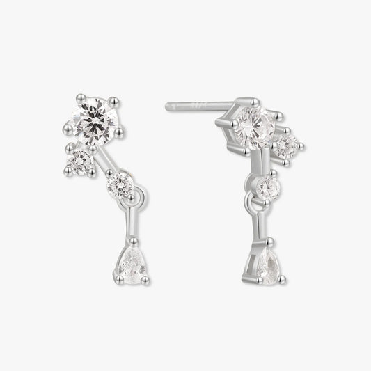 Silver earrings with clear gemstones on a white background