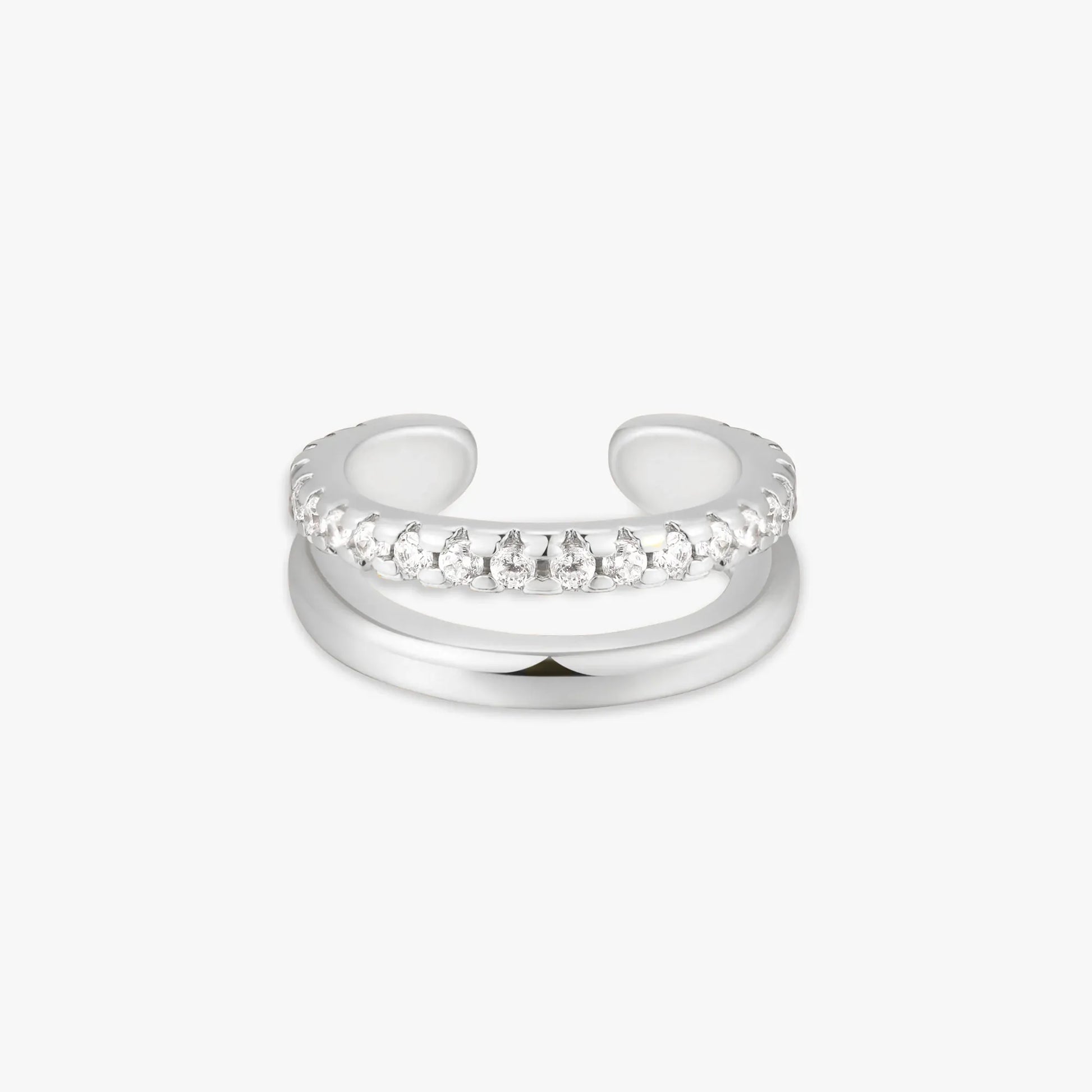 Silver ear cuff with clear gemstones on a white background