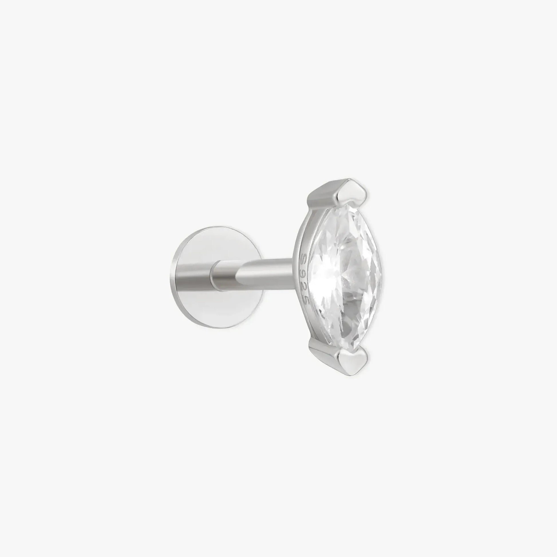 Silver earring with a clear gemstone on a white background