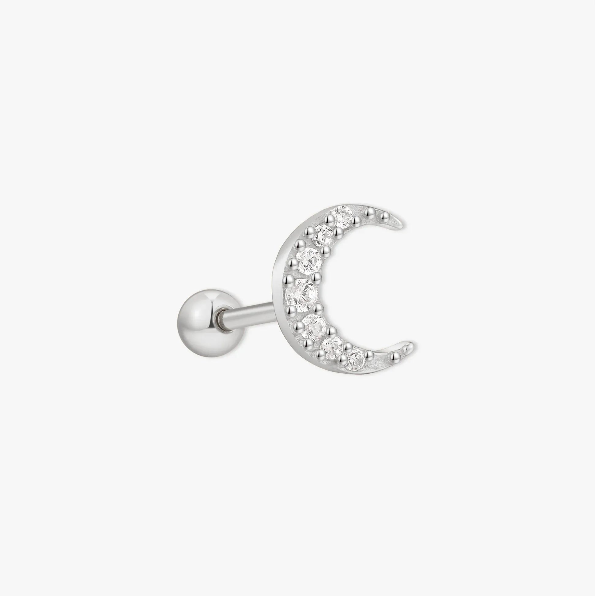 Silver ear cuff with small pearls on a white background