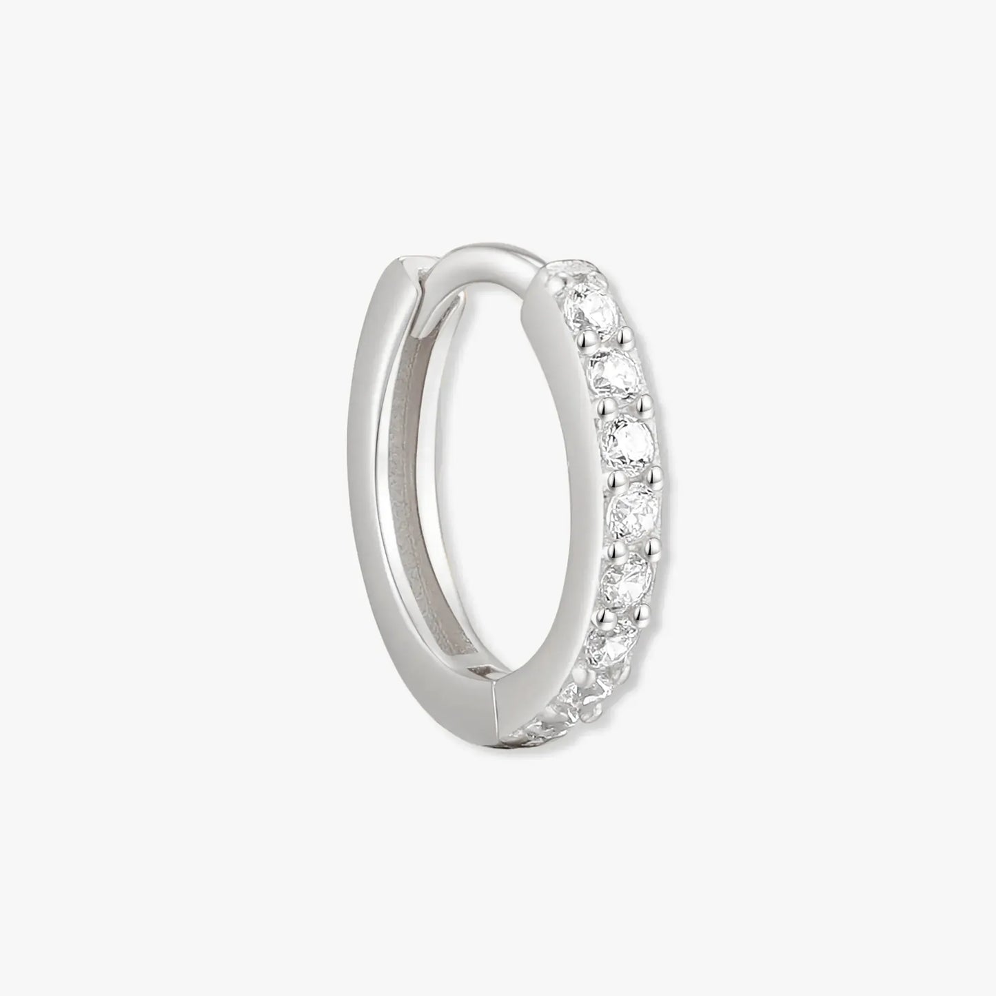 Silver hoop earring with embedded stones on a white background