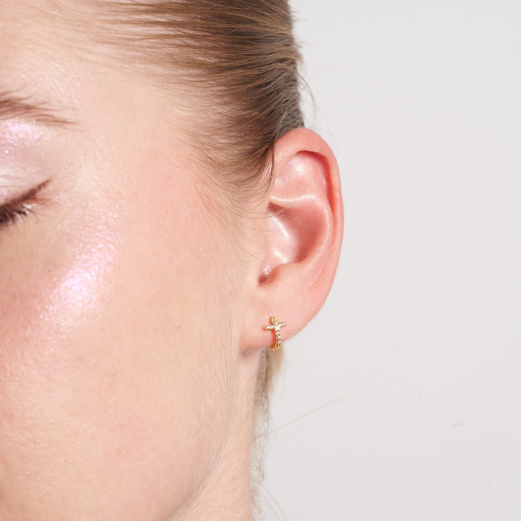 Crystal Paved Cross Huggie Hoops In Gold