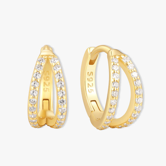Gold hoop earrings with clear stones on a white background