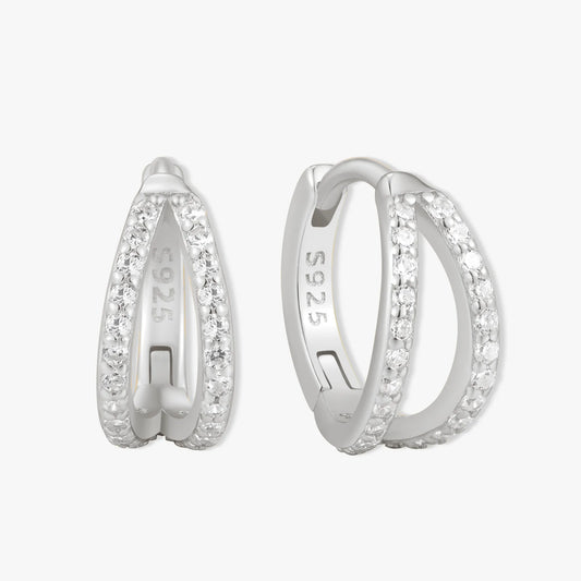 Silver hoop earrings with embedded stones on a white background