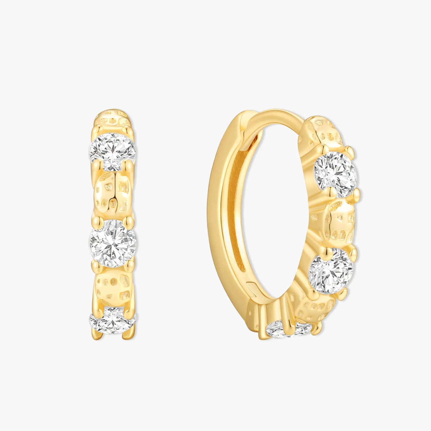 Gold hoop earrings with clear gemstones on a white background
