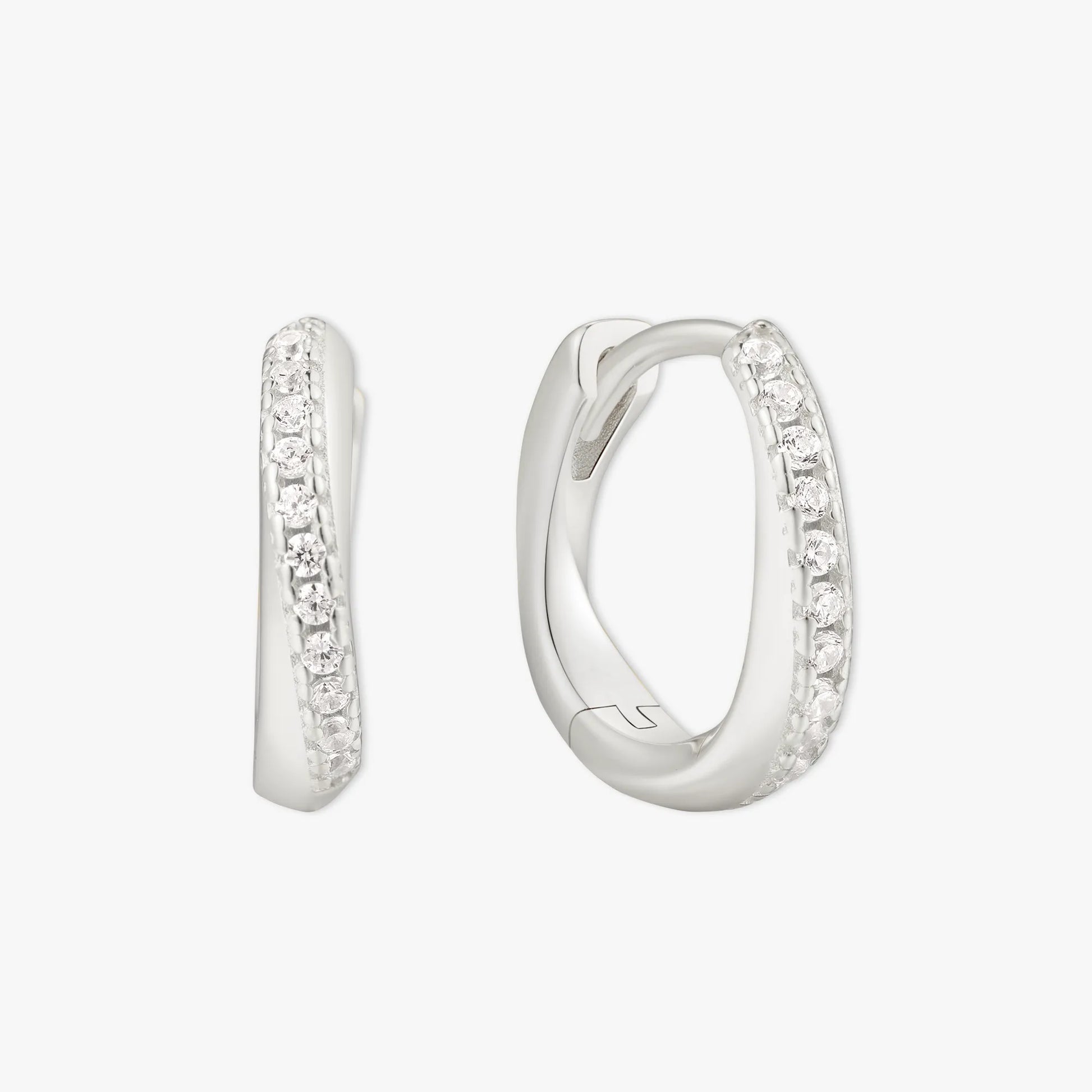 Silver hoop earrings with embedded stones on a white background