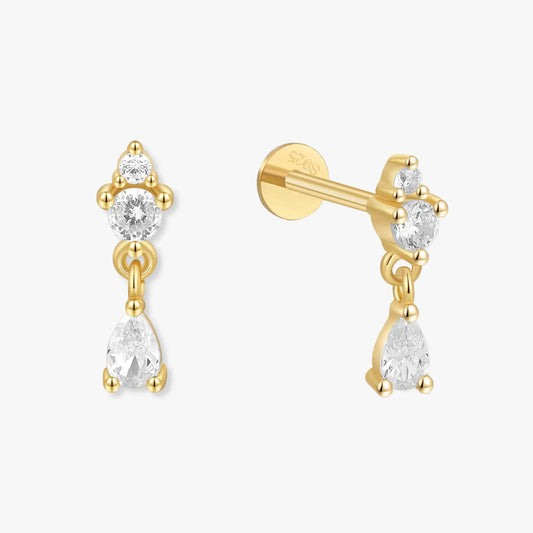 Gold earrings with clear gemstones on a white background