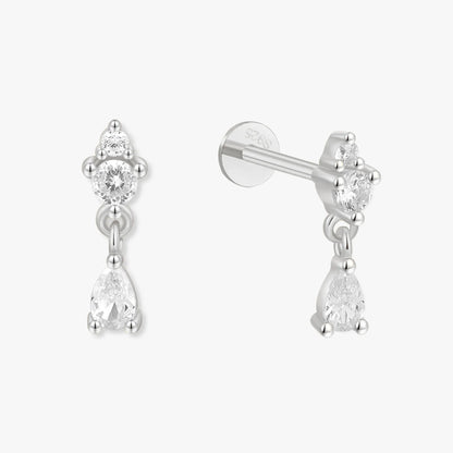 Pair of silver earrings with clear gemstones on a white background