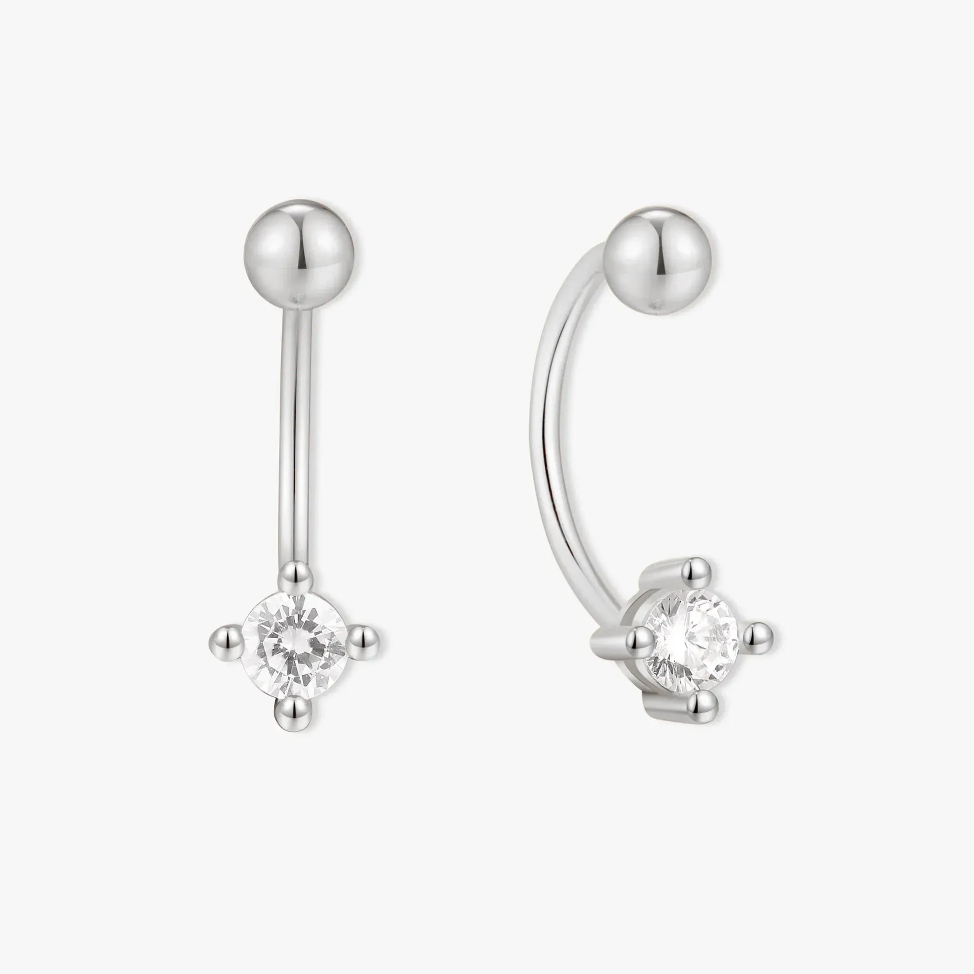 Silver earring with a clear gemstone on a white background