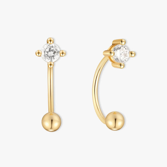 Gold earrings with clear gemstones on a white background
