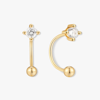 Gold earrings with clear gemstones on a white background