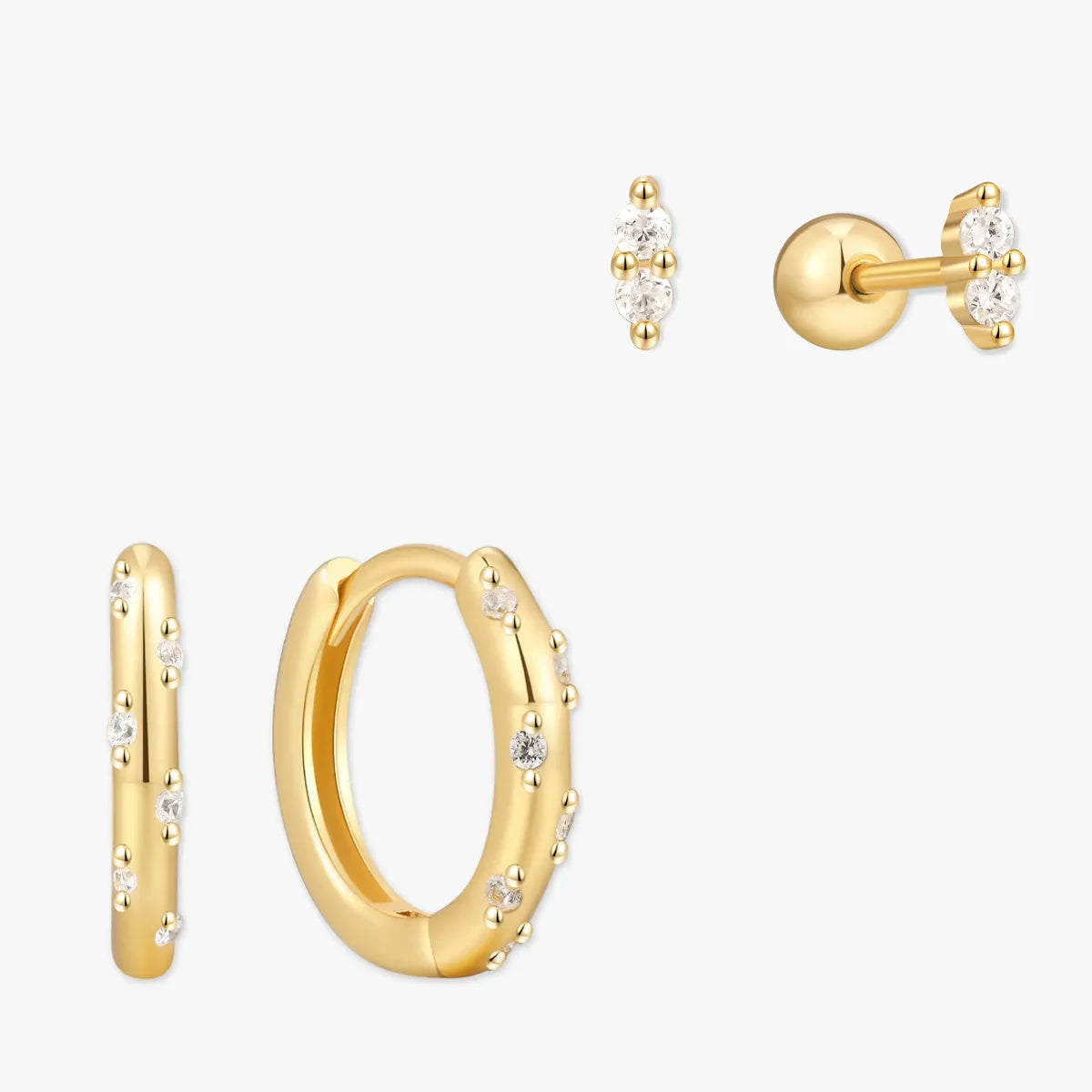 Gold hoop earrings and stud earrings on a white background