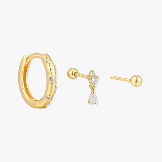 Gold hoop earrings with small diamonds on a white background