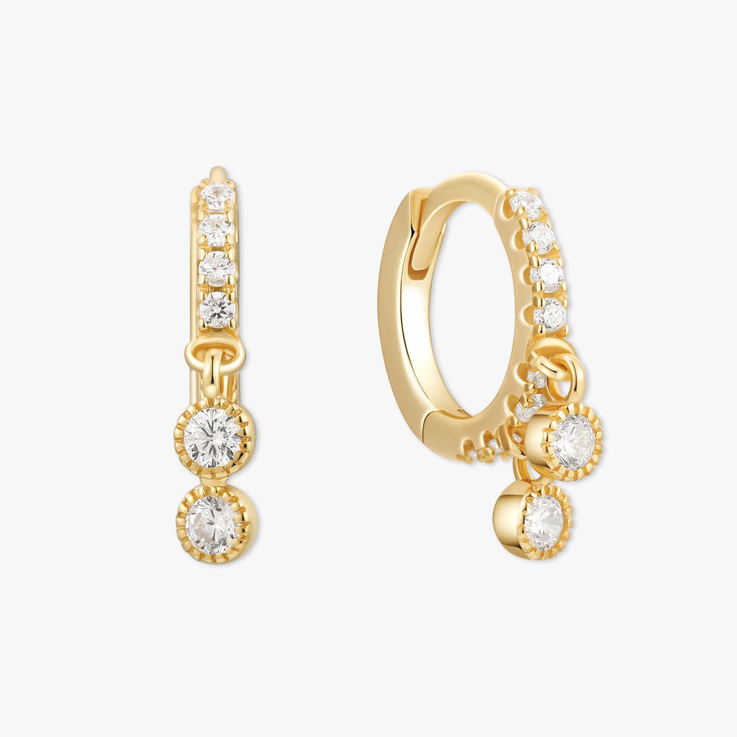 Gold hoop earrings with clear gemstones on a white background