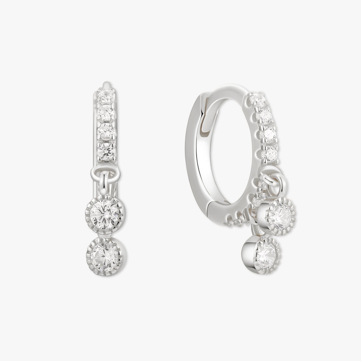 Pair of silver hoop earrings with clear gemstones on a white background