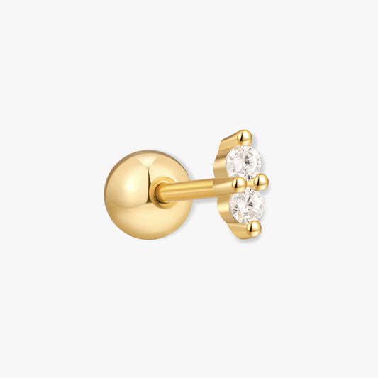 Gold earring with a clear gemstone on a white background