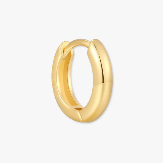 Gold hoop earring on a white background