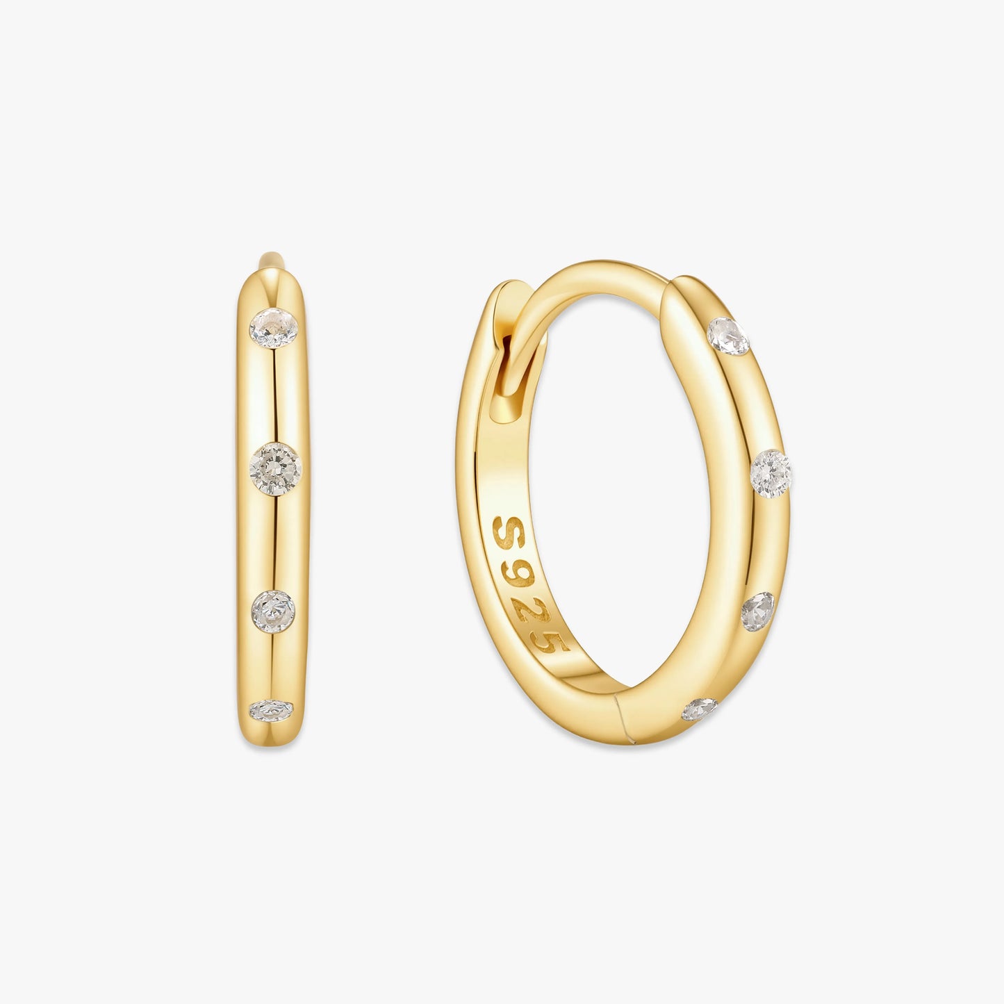 Gold hoop earrings with small diamonds on a white background