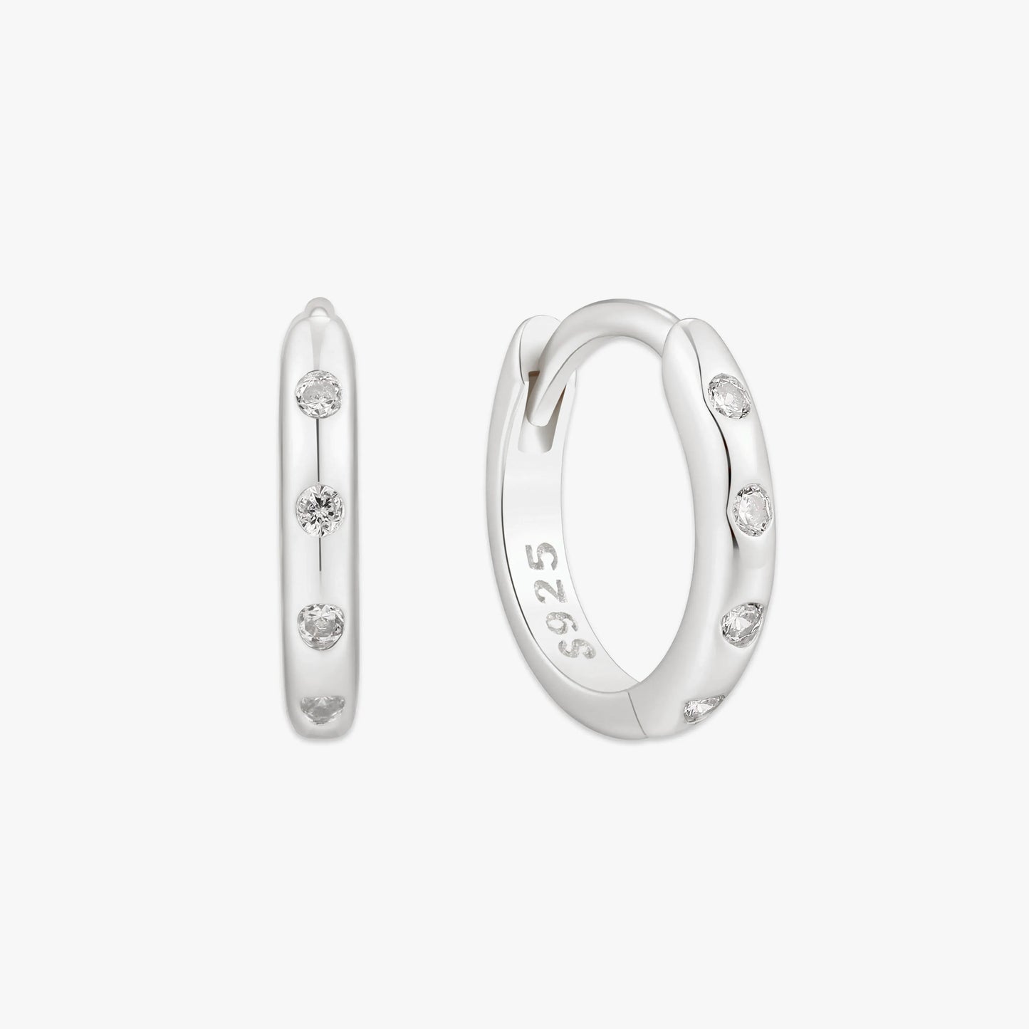 Silver hoop earrings with small diamonds on a white background