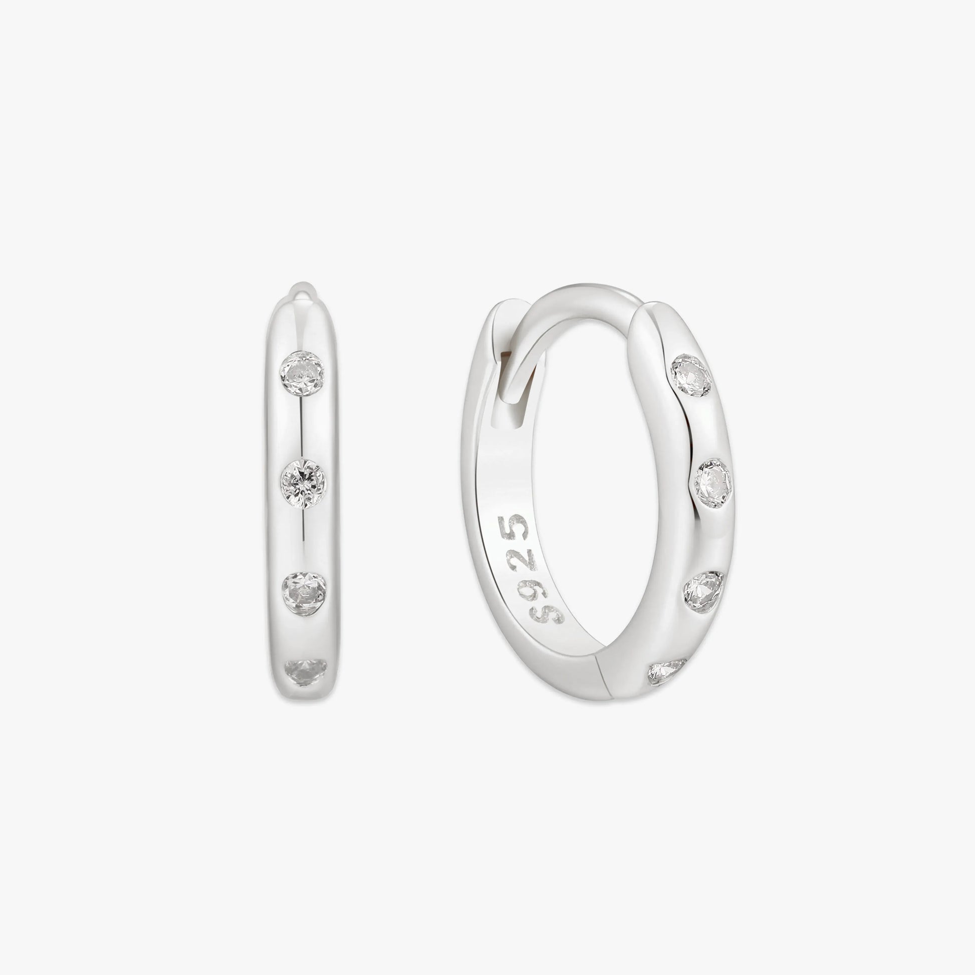 Silver hoop earrings with small diamonds on a white background