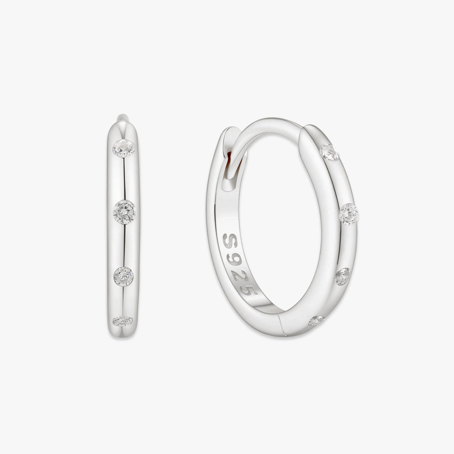 Silver hoop earrings with small diamonds on a white background