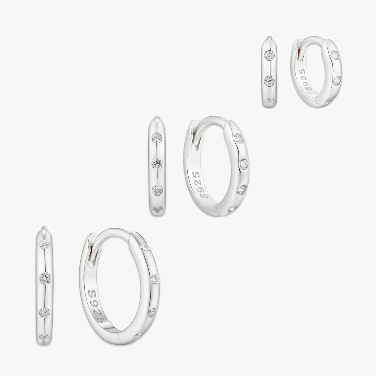 Set of silver hoop earrings on a white background