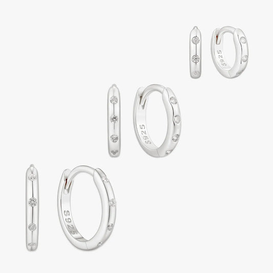 Set of silver hoop earrings on a white background