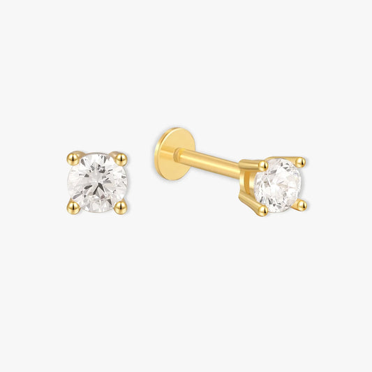 Gold stud earrings with clear gemstones on a white background