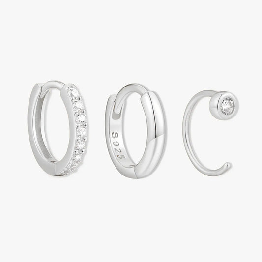 Set of silver hoop earrings on a white background