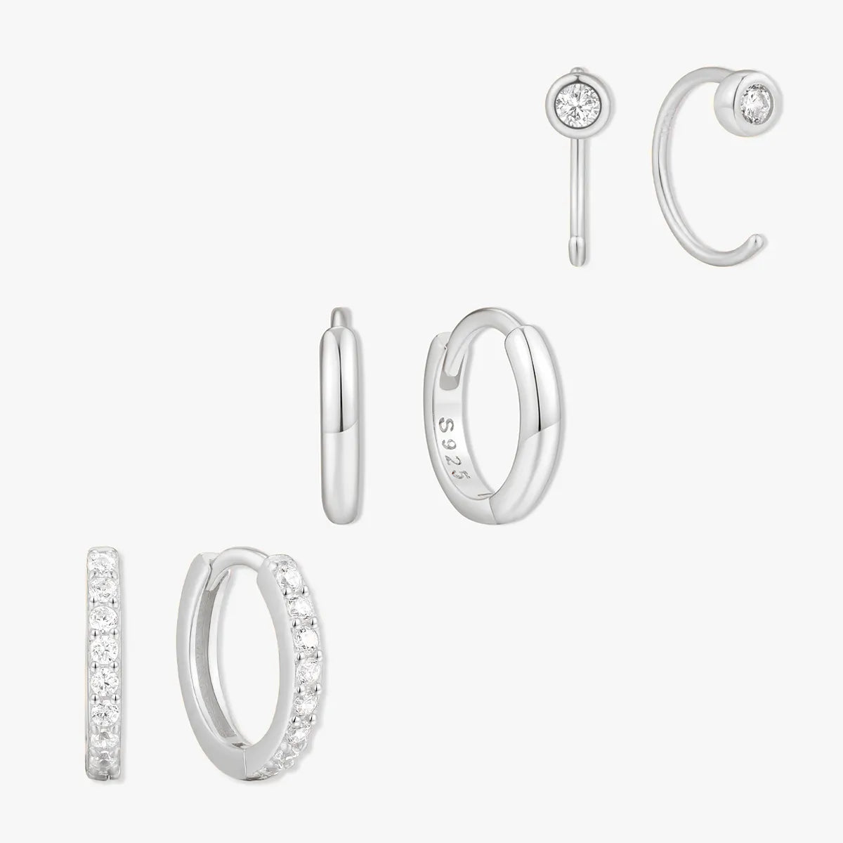 Set of silver hoop earrings on a white background