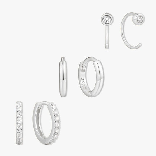 Set of silver hoop earrings on a white background
