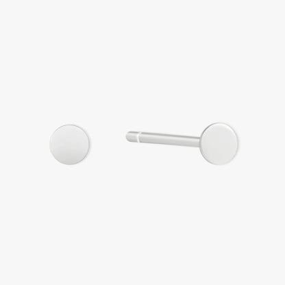 Pair of white round earrings on a light gray background