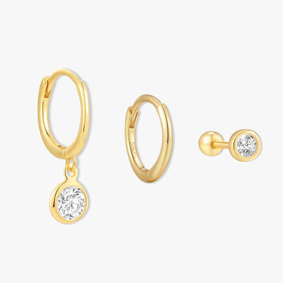 Gold hoop earrings with round gemstones on a white background