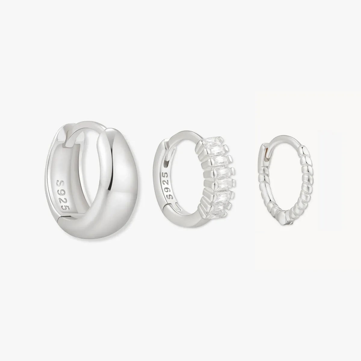 Set of silver hoop earrings on a white background