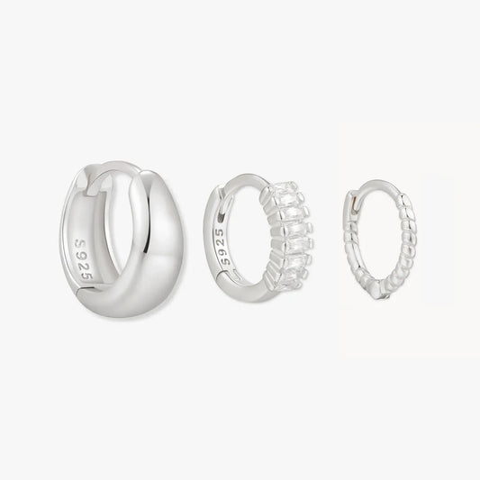 Set of silver hoop earrings on a white background