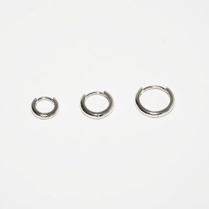 Three silver hoop earrings on a white background
