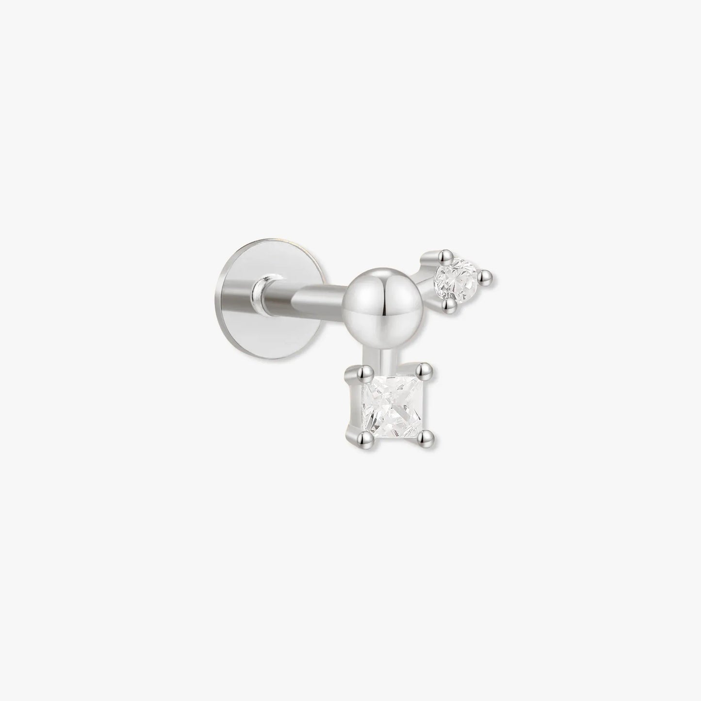 Silver earring with a small gemstone on a white background