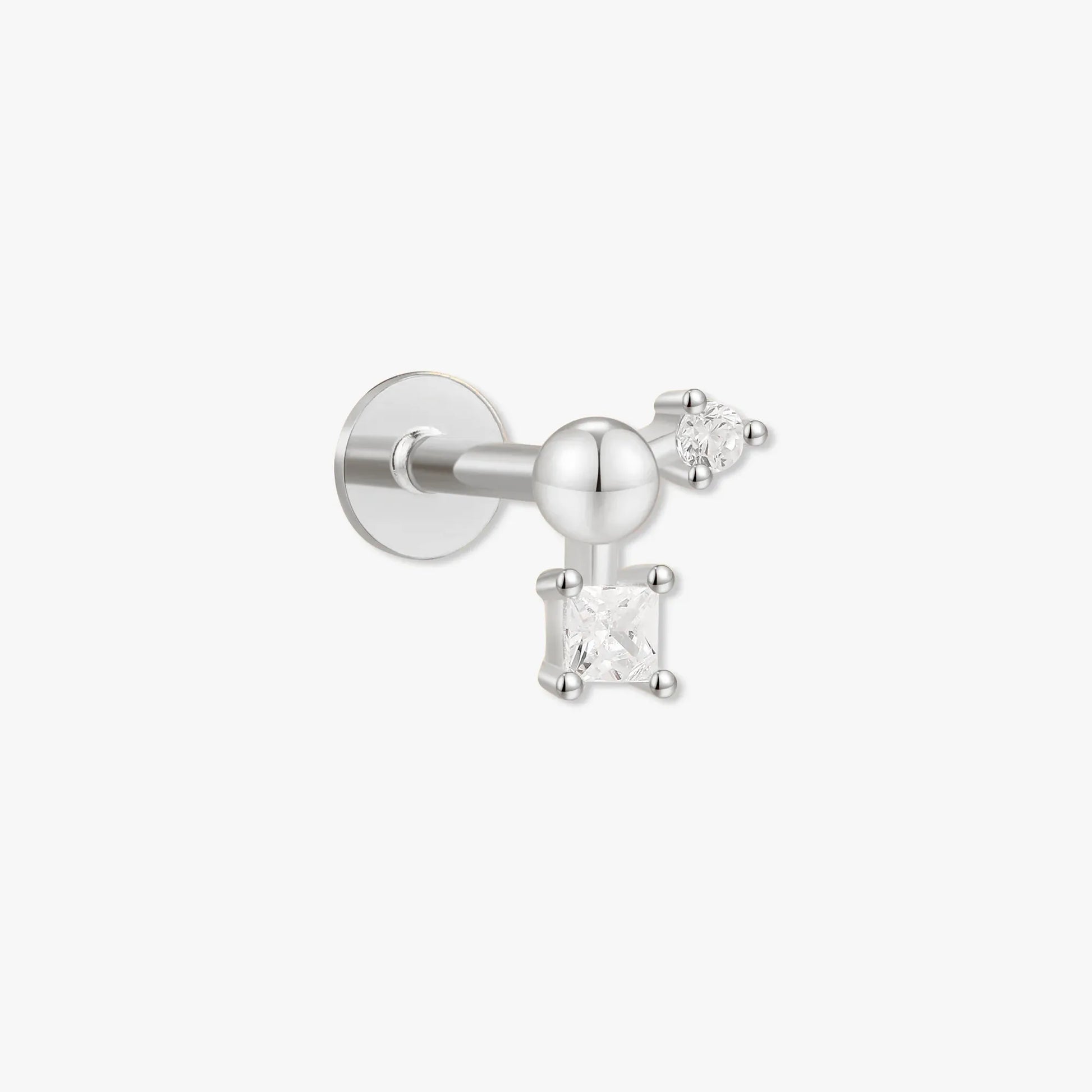 Silver earring with a small gemstone on a white background