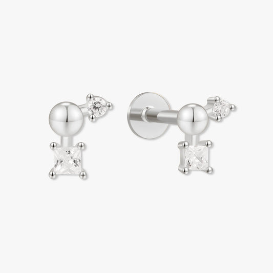Pair of silver earrings with clear gemstones on a white background