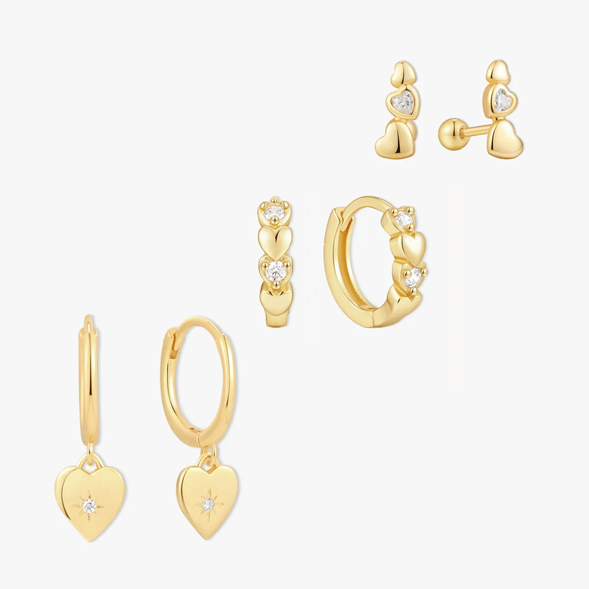 Set of gold hoop earrings with heart designs on a white background