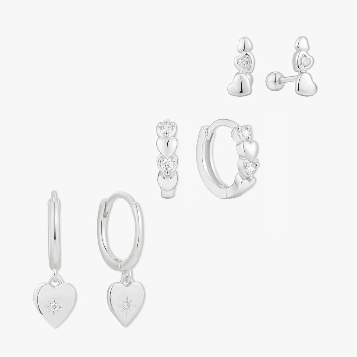 Set of silver earrings on a white background