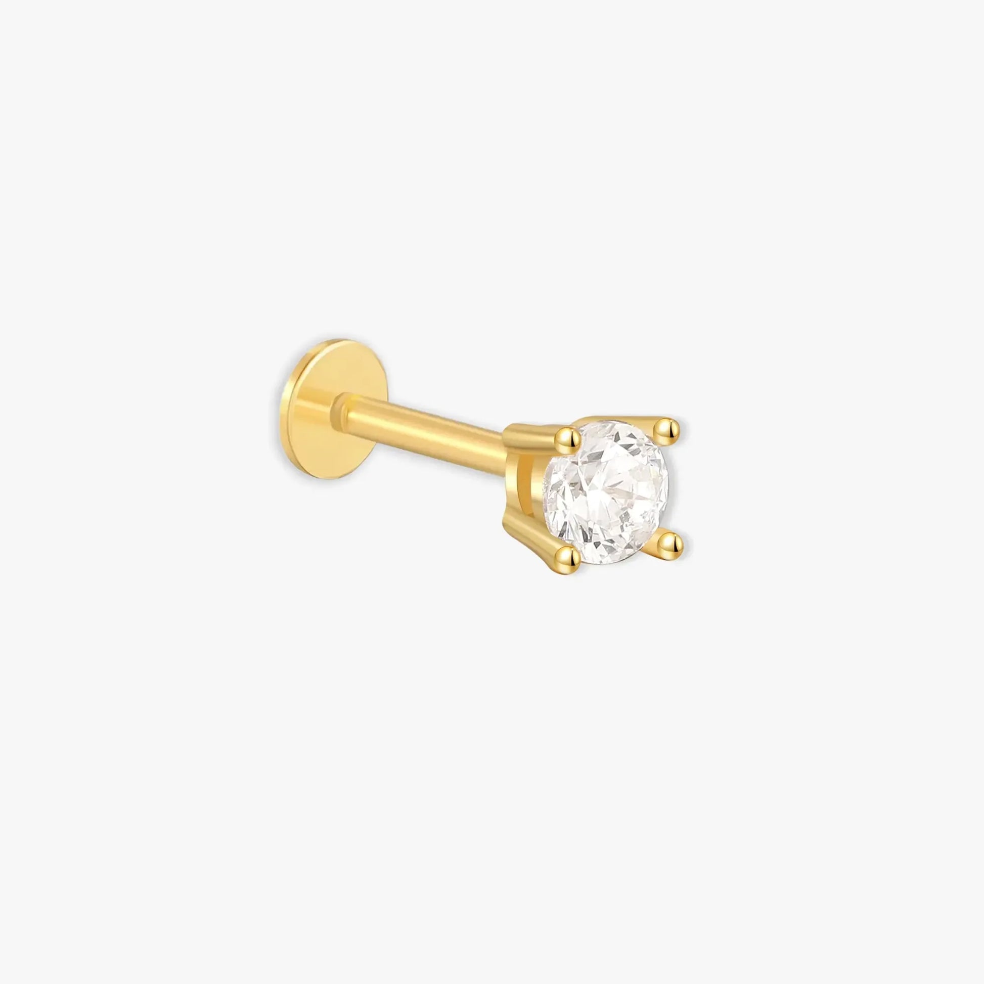 Gold nose ring with a clear gemstone on a white background