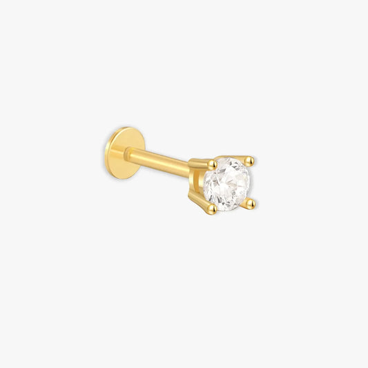 Gold nose ring with a clear gemstone on a white background