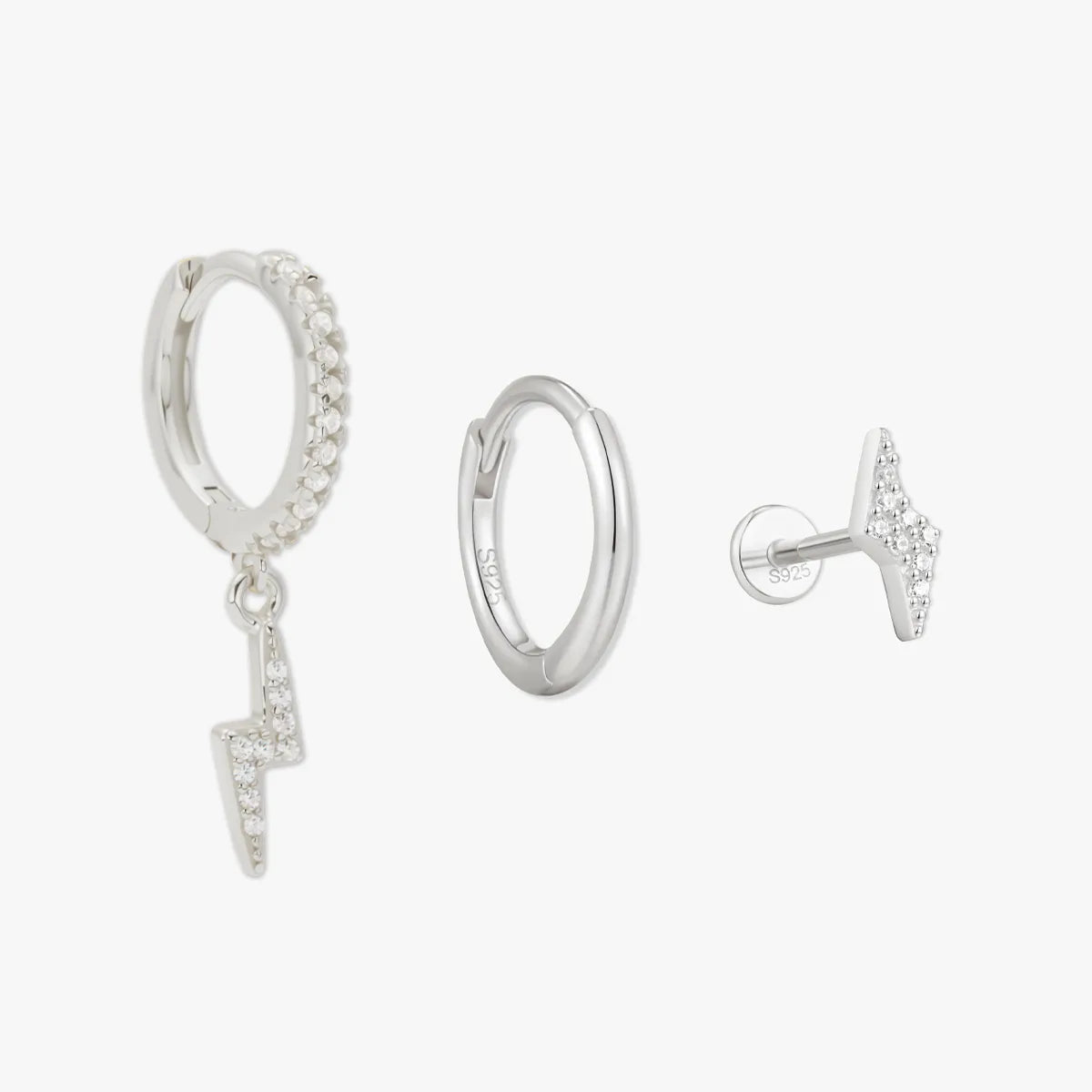 Silver hoop earrings with small charms on a white background