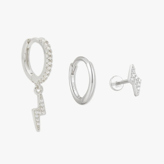 Silver hoop earrings with small charms on a white background