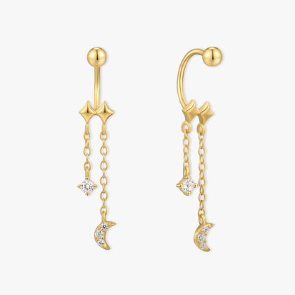 Gold ear cuffs with star and moon charms on a white background